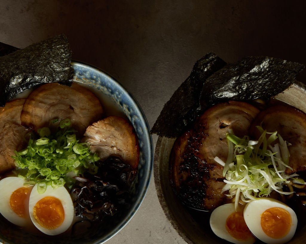 Two ramen bowls side by side — tonkotsu and shoyu style